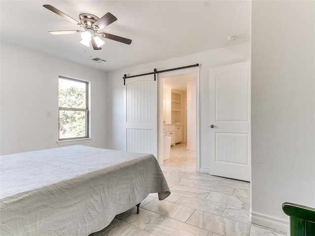 bedroom featuring a barn door and ceiling fan