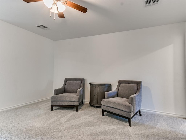 living area featuring ceiling fan and light carpet