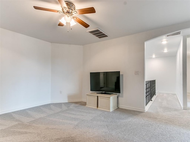 unfurnished living room featuring ceiling fan and light colored carpet