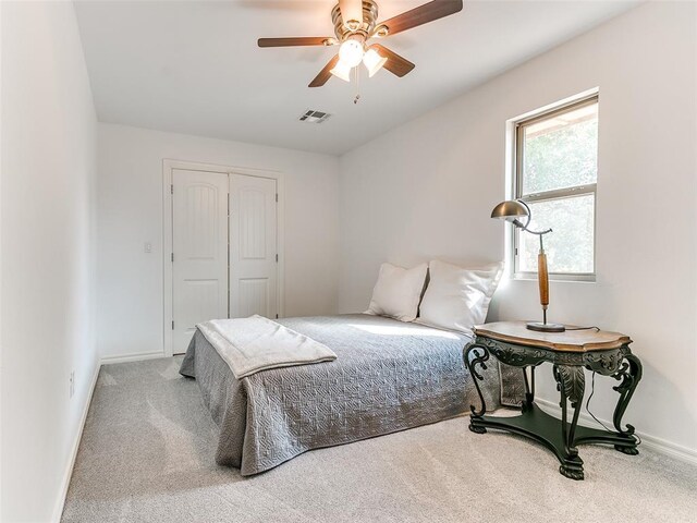 carpeted bedroom with a closet and ceiling fan