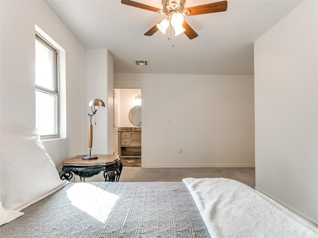 bedroom featuring multiple windows, ensuite bathroom, and carpet floors