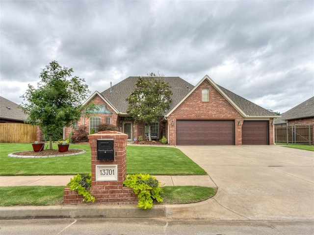 view of front facade with a front yard and a garage