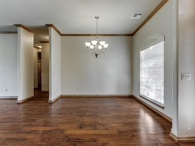 spare room with a notable chandelier, dark hardwood / wood-style floors, and crown molding