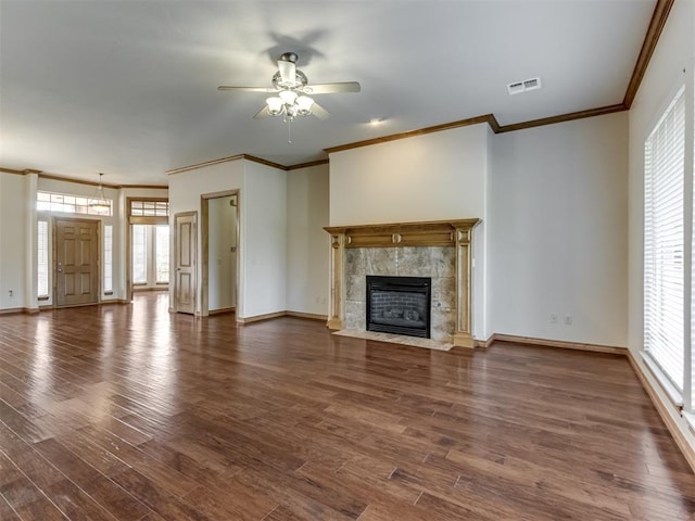 unfurnished living room featuring a fireplace, dark hardwood / wood-style floors, ceiling fan, and ornamental molding