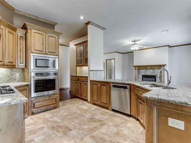 kitchen featuring backsplash, crown molding, sink, and appliances with stainless steel finishes