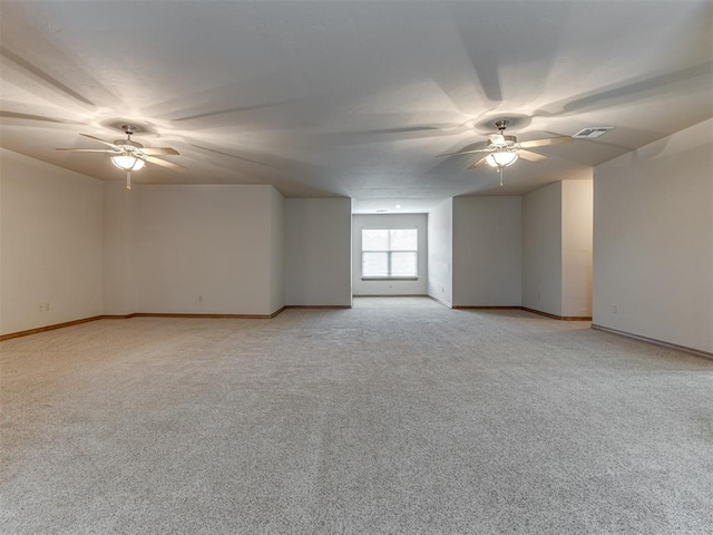 carpeted spare room featuring ceiling fan