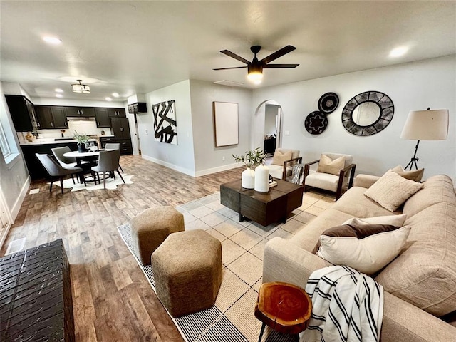 living room featuring light wood-type flooring and ceiling fan