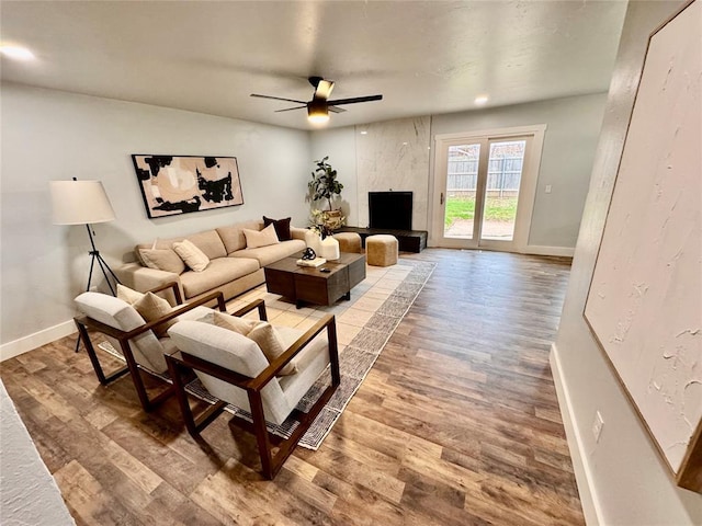 living room featuring hardwood / wood-style flooring and ceiling fan