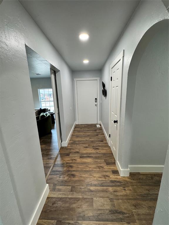 corridor featuring dark hardwood / wood-style floors