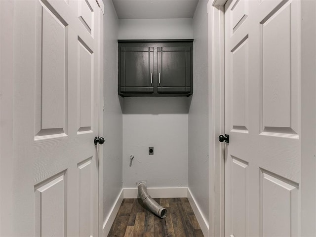 laundry room with cabinets, hookup for an electric dryer, and dark wood-type flooring