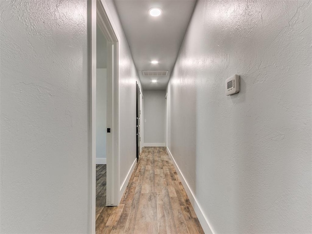 hall with hardwood / wood-style flooring