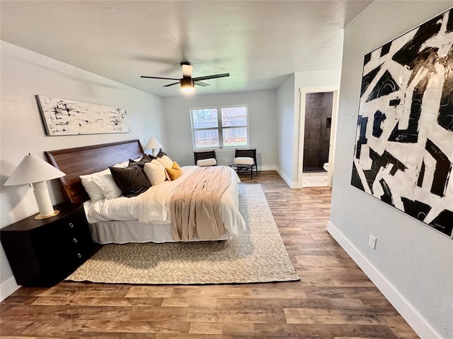 bedroom featuring hardwood / wood-style flooring, ceiling fan, and connected bathroom