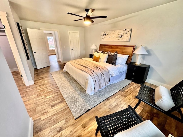 bedroom with ceiling fan and light wood-type flooring