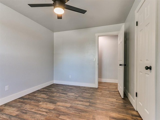 empty room featuring ceiling fan and dark hardwood / wood-style floors