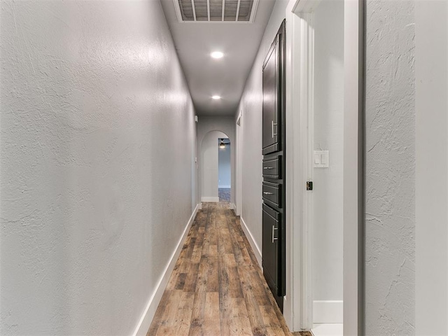 hall with hardwood / wood-style flooring