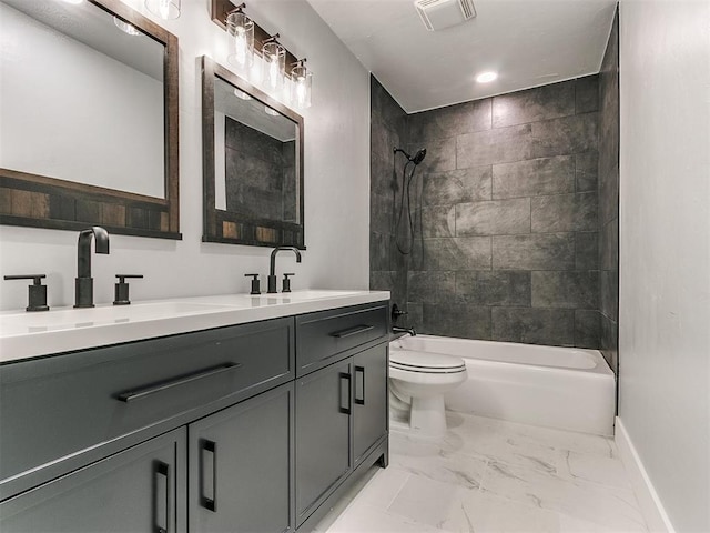 full bathroom featuring toilet, vanity, and tiled shower / bath