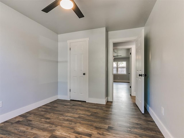 unfurnished bedroom with a closet, ceiling fan, and dark hardwood / wood-style flooring