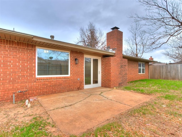 rear view of property with a patio area and a yard