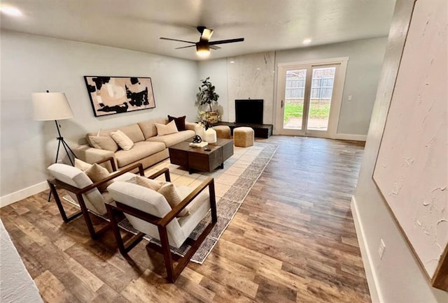 living room with ceiling fan and hardwood / wood-style floors