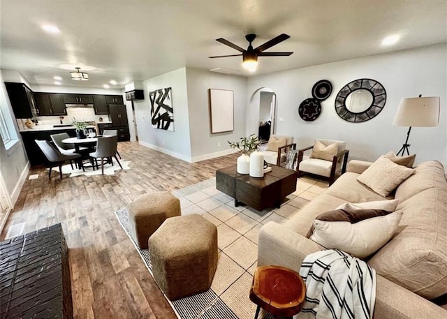 living room with light wood-type flooring and ceiling fan