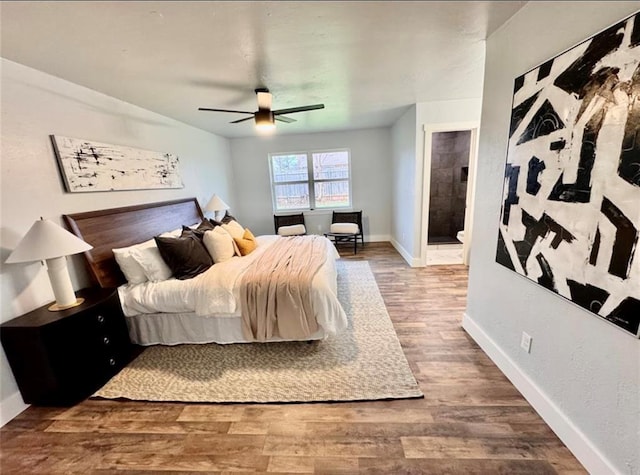 bedroom featuring ceiling fan, ensuite bathroom, and wood-type flooring