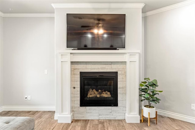 details featuring a stone fireplace, crown molding, and hardwood / wood-style flooring