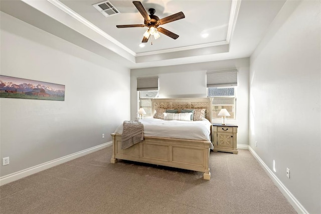 bedroom with ceiling fan, light colored carpet, a raised ceiling, and crown molding