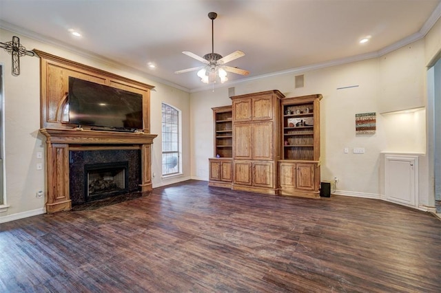 unfurnished living room with dark hardwood / wood-style floors, ceiling fan, a fireplace, and crown molding