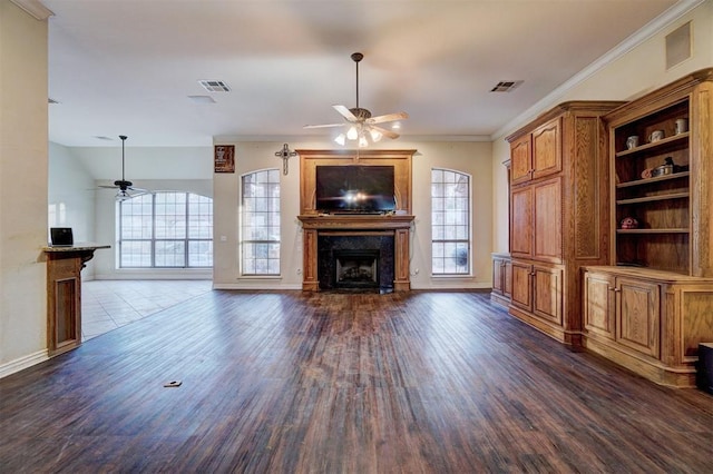 unfurnished living room featuring crown molding, dark hardwood / wood-style floors, and ceiling fan