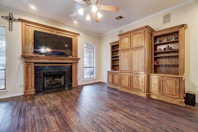 unfurnished living room with dark wood-type flooring, a fireplace, ornamental molding, and ceiling fan