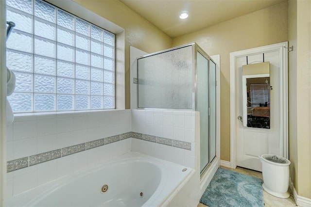 bathroom with tile patterned flooring, plenty of natural light, and separate shower and tub