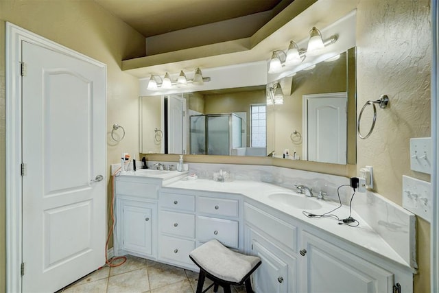 bathroom featuring tile patterned flooring, vanity, and a shower with door