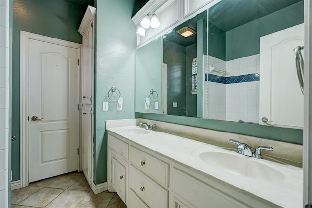 bathroom featuring tile patterned flooring, vanity, and tiled shower