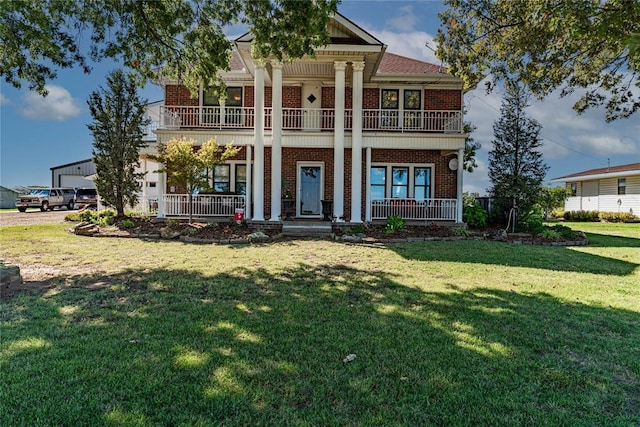 greek revival inspired property featuring covered porch and a front lawn