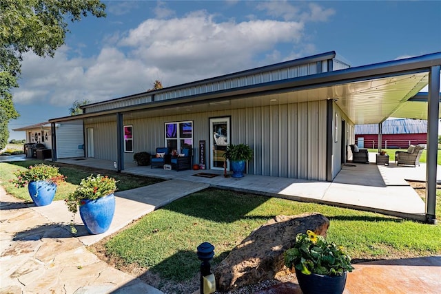 view of front of house with an outdoor hangout area, a front lawn, and a patio area