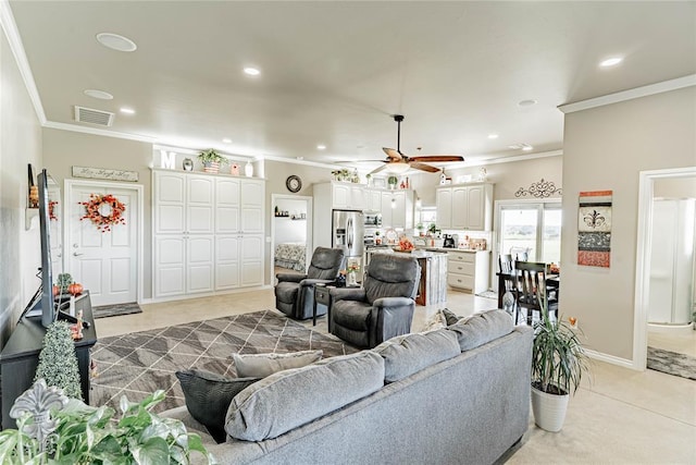 carpeted living room featuring crown molding and ceiling fan