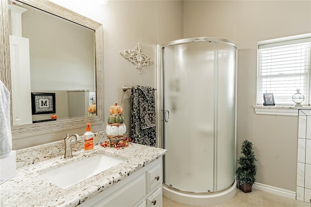 bathroom with vanity and a shower with shower door