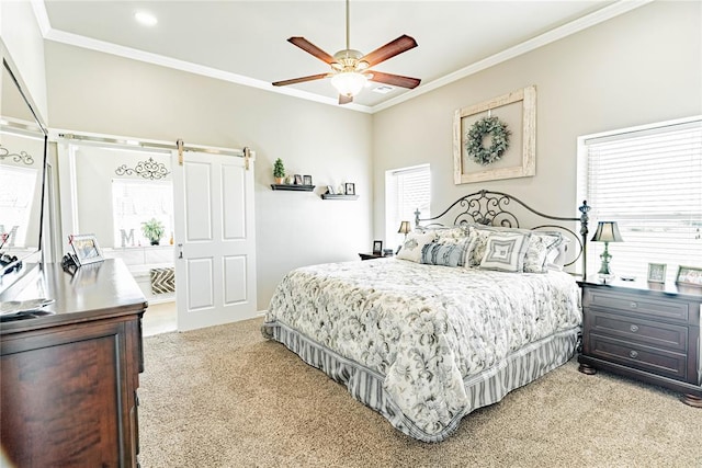 carpeted bedroom featuring ceiling fan, a barn door, and ornamental molding