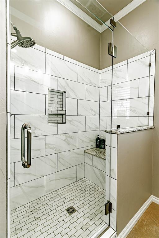 bathroom with tile patterned floors and walk in shower