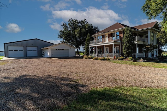 view of front of house with an outbuilding, a garage, and covered porch