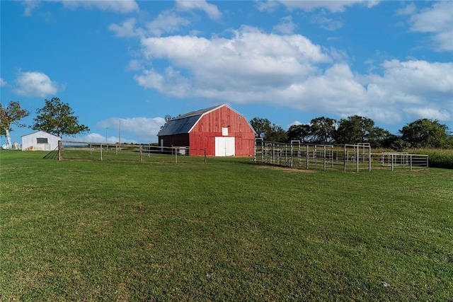 view of yard with a rural view and an outdoor structure