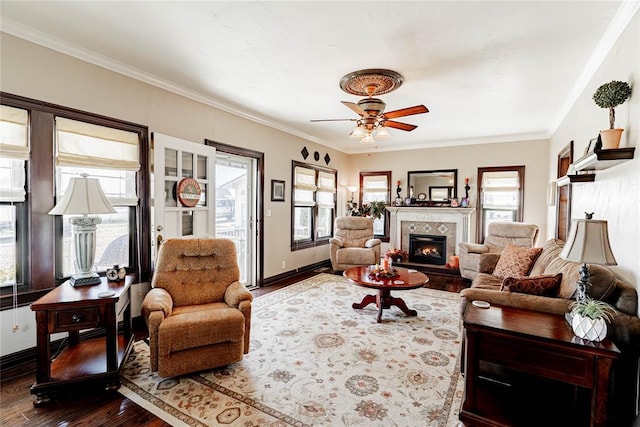 living room featuring ornamental molding, ceiling fan, and dark wood-type flooring