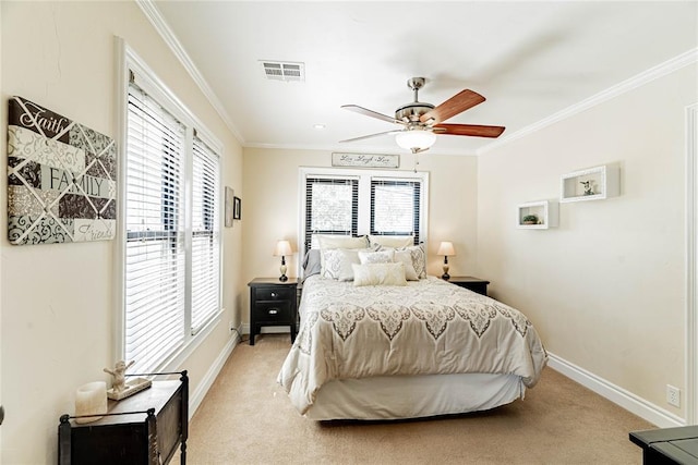 bedroom featuring ceiling fan, crown molding, and light colored carpet