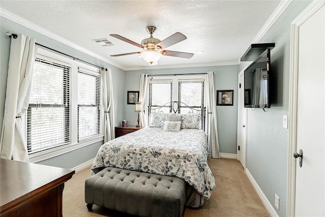 carpeted bedroom with ceiling fan, a textured ceiling, and ornamental molding