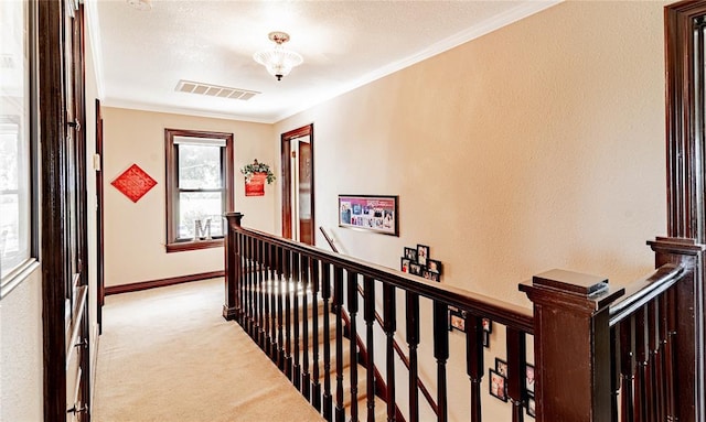 hall with light carpet and crown molding