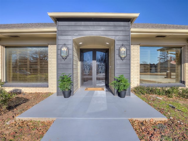 entrance to property with french doors and brick siding