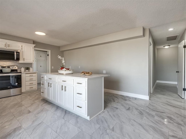 kitchen featuring stainless steel appliances, a kitchen island, a textured ceiling, decorative backsplash, and white cabinets