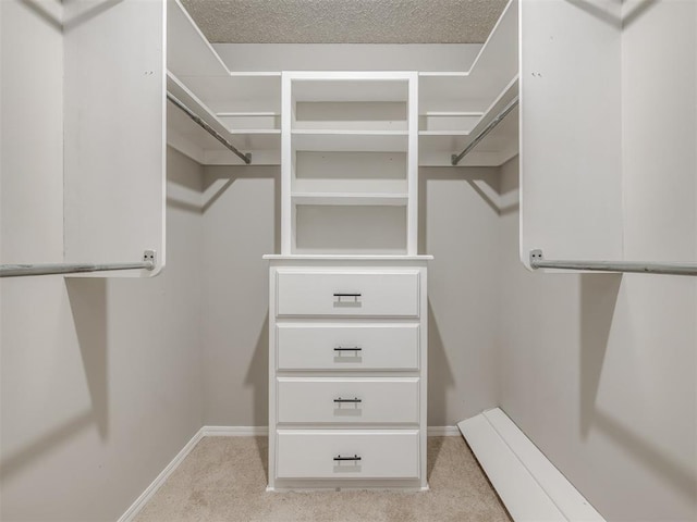 walk in closet featuring light carpet