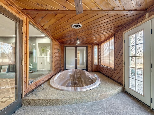 unfurnished sunroom with vaulted ceiling, wood ceiling, and a hot tub