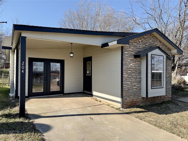 view of exterior entry featuring french doors